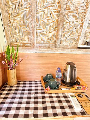 a table with a tray on a checkered floor at Penida Hills in Nusa Penida
