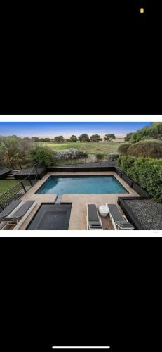 two pictures of a swimming pool with two chairs at St Georges Luxury Beach House in Torquay
