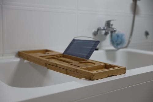 a wooden tray sitting on top of a bathroom sink at SamDalChae in Seogwipo