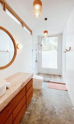 a bathroom with two sinks and a tub and a window at Punta Punta Surf Retreat in General Luna