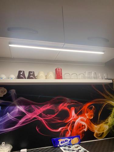 a shelf with colorful items in a refrigerator at Paris Sud-porte de Gentilly mignon T2 250 m de Paris in Gentilly