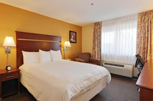 a hotel room with a large bed and a window at Georgetown Inn Seattle in Seattle