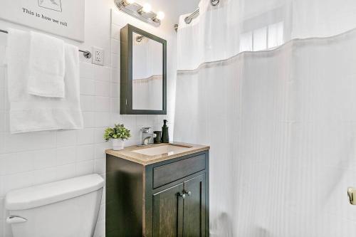 ein Bad mit einem Waschbecken und einem Spiegel in der Unterkunft Beautiful 1BR Brick Home in Historic Hyde Park in Chicago