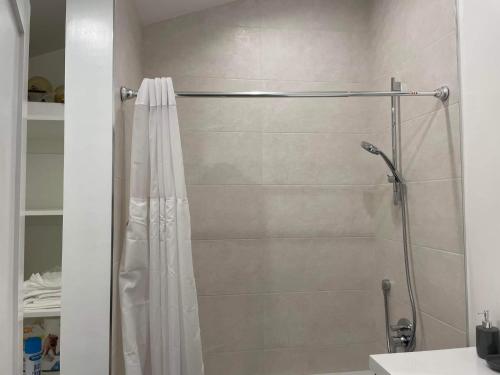 a shower with a shower curtain in a bathroom at Gated private house with own parking Sherman Oaks in Los Angeles