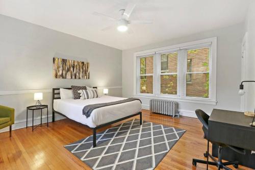a white bedroom with a bed and a piano at Spacious 4BR APT in Historic Hyde Park near Beach in Chicago