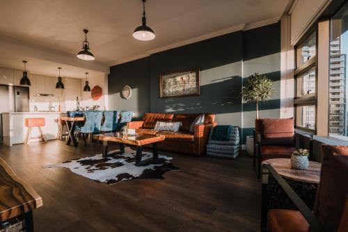 a living room with a couch and a table at Twilight Olympic Park 2x King-beds Lux Apt in Sydney