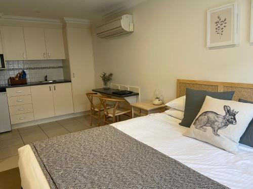a bedroom with a bed with a kangaroo pillow on it at Millthorpe Motel in Millthorpe