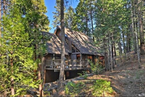 a log home with a deck in the woods at Arrowhead Lake Cabin pool table stunning views in Lake Arrowhead