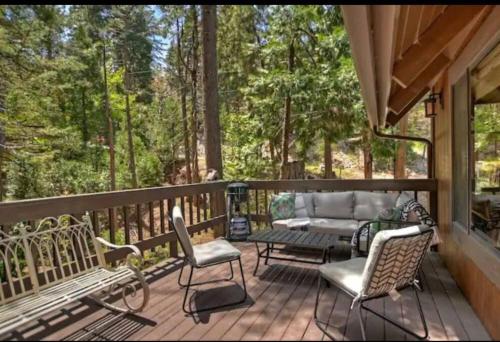 a porch with chairs and a couch on a deck at Arrowhead Lake Cabin pool table stunning views in Lake Arrowhead