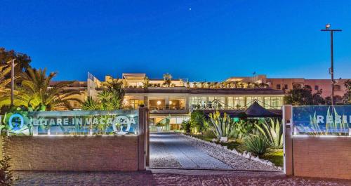 a large building with a gate in front of it at Abitare in Vacanza in La Caletta