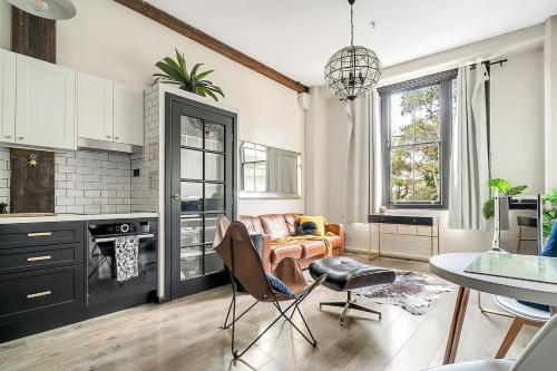 a kitchen and living room with a table and chairs at The Stylist's House - A Chic Inner City Landmark in Sydney