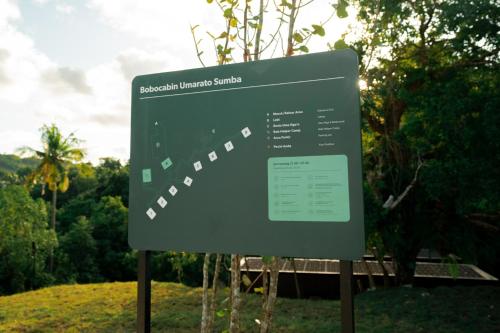 a sign for a park with trees in the background at Bobocabin Umarato, Sumba in Waikabubak