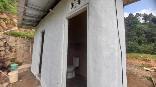 a bathroom with a toilet in the side of a building at Paseban Mountain View Camping Ground in Pondok Cipaseban