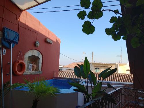 a red building with a swimming pool in front of it at H&M Prive HOME MÀRGARITES RETHYMNO 115sqm in Margarítai