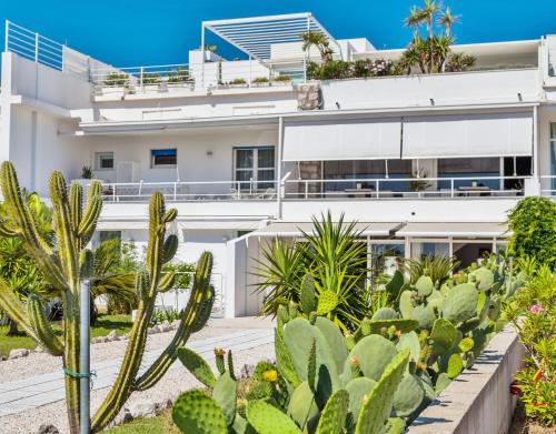 a house with cacti in front of it at Abitare in Vacanza in La Caletta