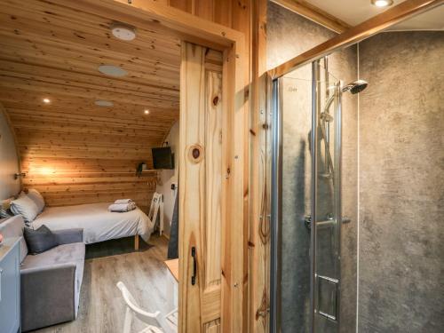 a bathroom with a shower and a bed in a room at Forest in Dalton in Furness