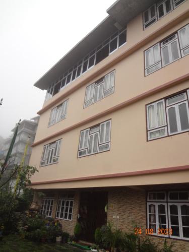 a building with a lot of windows on it at The Bliss Homestay in Gangtok