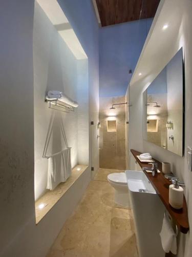 a white bathroom with a sink and a toilet at Las Lupitas Hotel Boutique in Campeche