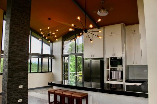 a kitchen with a black counter and some windows at Bella Villa Coron in Coron