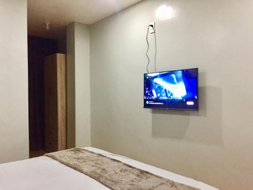 a room with a flat screen tv on the wall at Mamay's Homestay in Tagbilaran City