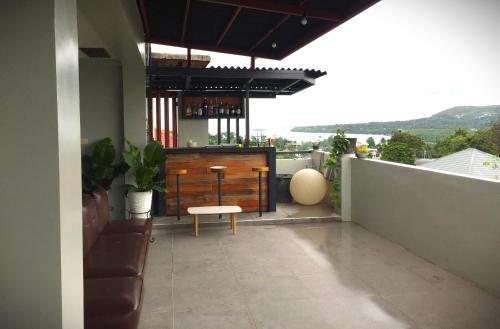 a patio with a bar on the roof of a house at Mamay's Homestay in Tagbilaran City