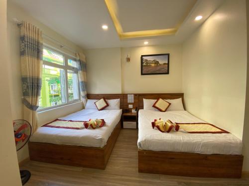 Giường trong phòng chung tại An Nguyên Hotel