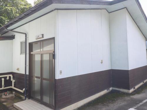 an entrance to a building with a glass door at Shugyoku no Yu Yakushido Onsen in Oshu