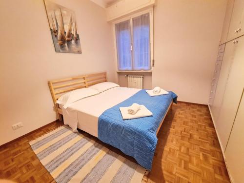 a bedroom with a bed with two towels on it at Sail Away Camogli in Camogli
