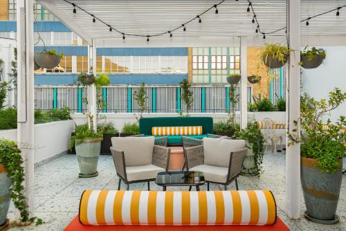 a patio with chairs and a couch and a table at The Carrington Aparthotel by Totalstay in Cape Town