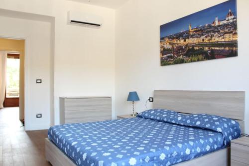 a bedroom with a bed and a painting on the wall at Art Apartment Stazione B in Florence
