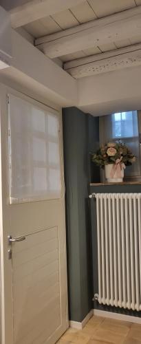 a room with a white door and a radiator at small miramare appartamento sogno sul mare in Trieste