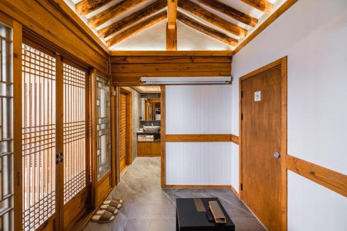 a hallway with wood paneling and a ceiling at Luxury hanok with private bathtub - SN05 in Seoul