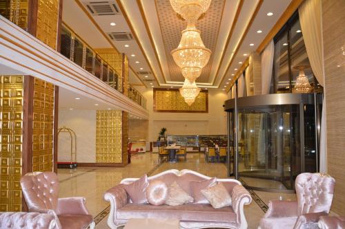 a lobby with a couch and chairs in a building at Haldi Otel in Van