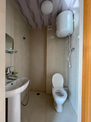 a bathroom with a toilet and a sink at Hotel "Qeti" in Shekhvetili