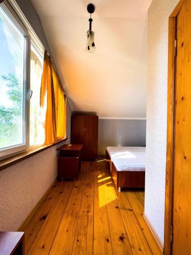 a bedroom with a bed and a window at Hotel "Qeti" in Shekhvetili