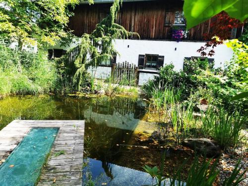 a pond in the backyard of a house at Chalet in Saalfelden near Ski Slopes in Saalfelden am Steinernen Meer