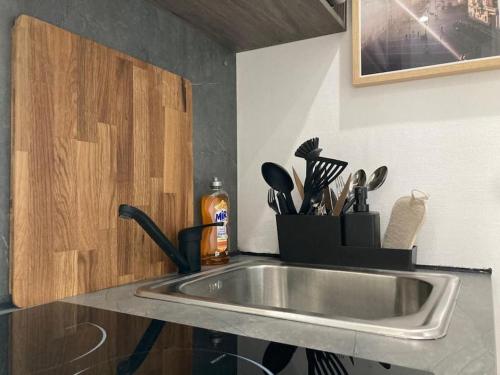 a kitchen counter with a stainless steel sink at Chambre indépendante en face de la Gare Lille Flandres in Lille