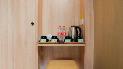a shelf in a room with a coffee maker on it at Bobocabin Pangalengan, Bandung in Pengalengan