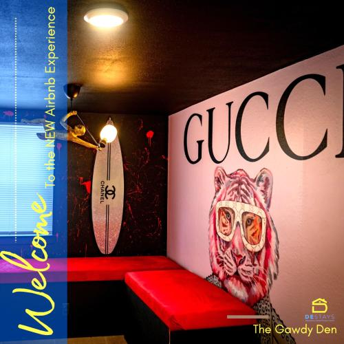a red bench with a painting of a tiger with glasses at The Gawdy Den with Fast WIFI 2 minutes from Downtown Houston! in Houston