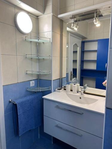a bathroom with a sink and a mirror at Apartament de lux, zona centrala in Gura Humorului