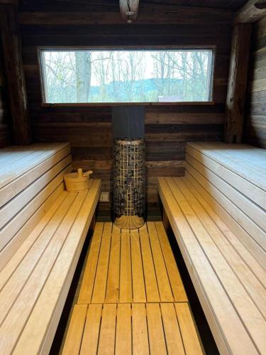an empty sauna with a large window in the middle at Chalet Apartments Maštal in Železná Ruda