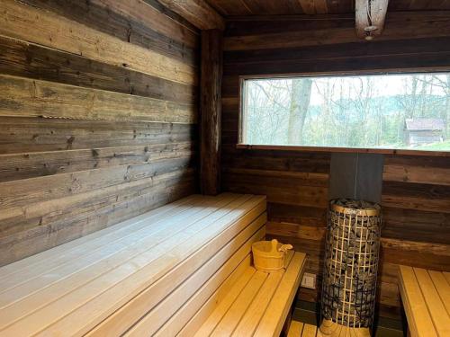 a sauna with a window in a wooden cabin at Chalet Apartments Maštal in Železná Ruda