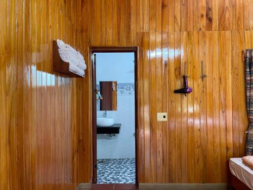 a bathroom with a door leading to a sink at Duong Cong Chich Homestay in Lạng Sơn