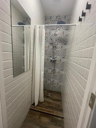 a bathroom with a shower with a mirror at Apple Economy Hotel in Kaunas