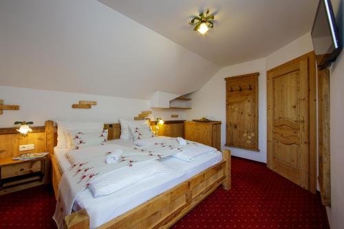 a bedroom with a large bed with christmas decorations on it at Panorama Hotel Gasthof Leidingerhof in Mondsee