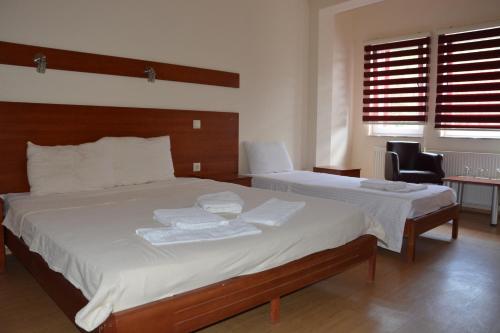 a bedroom with two beds with towels on them at Arabella Hotel in Kičevo