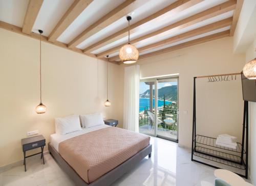 a bedroom with a bed and a view of the ocean at Mylos Mountain Villas- Villa Giorgio in Agios Nikitas
