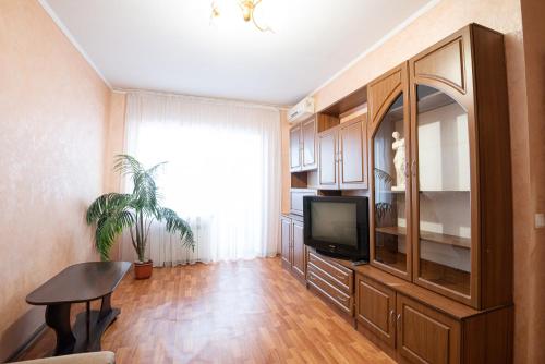 a living room with a flat screen tv and a table at Дашковича 30, центр міста in Cherkasy
