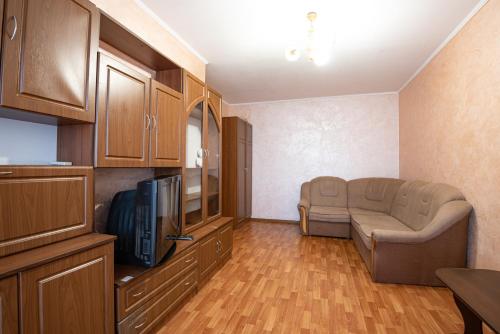 a living room with a couch and a tv at Дашковича 30, центр міста in Cherkasy