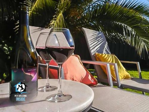 two glasses of wine are sitting on a table at Coastal Vibe, 4 beds Short Walk to the Beach in Aldinga Beach